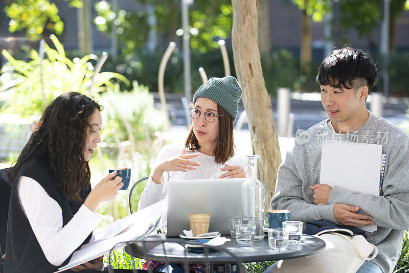 Three students studying at the café